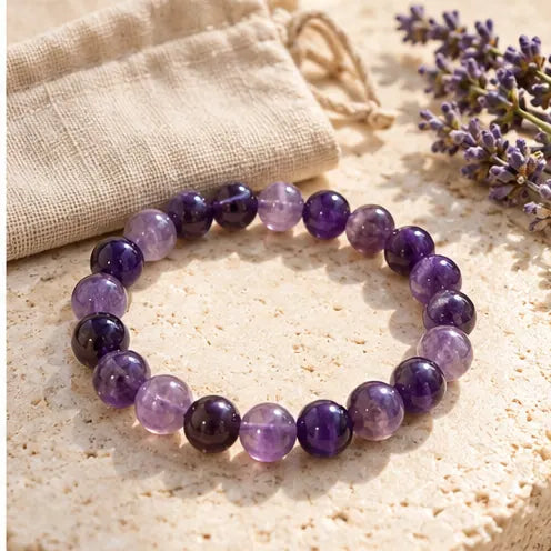 Amethyst bracelet beside linen pouch
