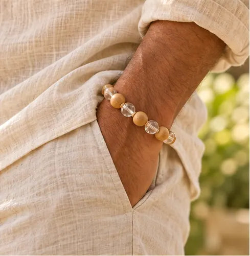 ON THE WRIST · Warm wood, clear crystal