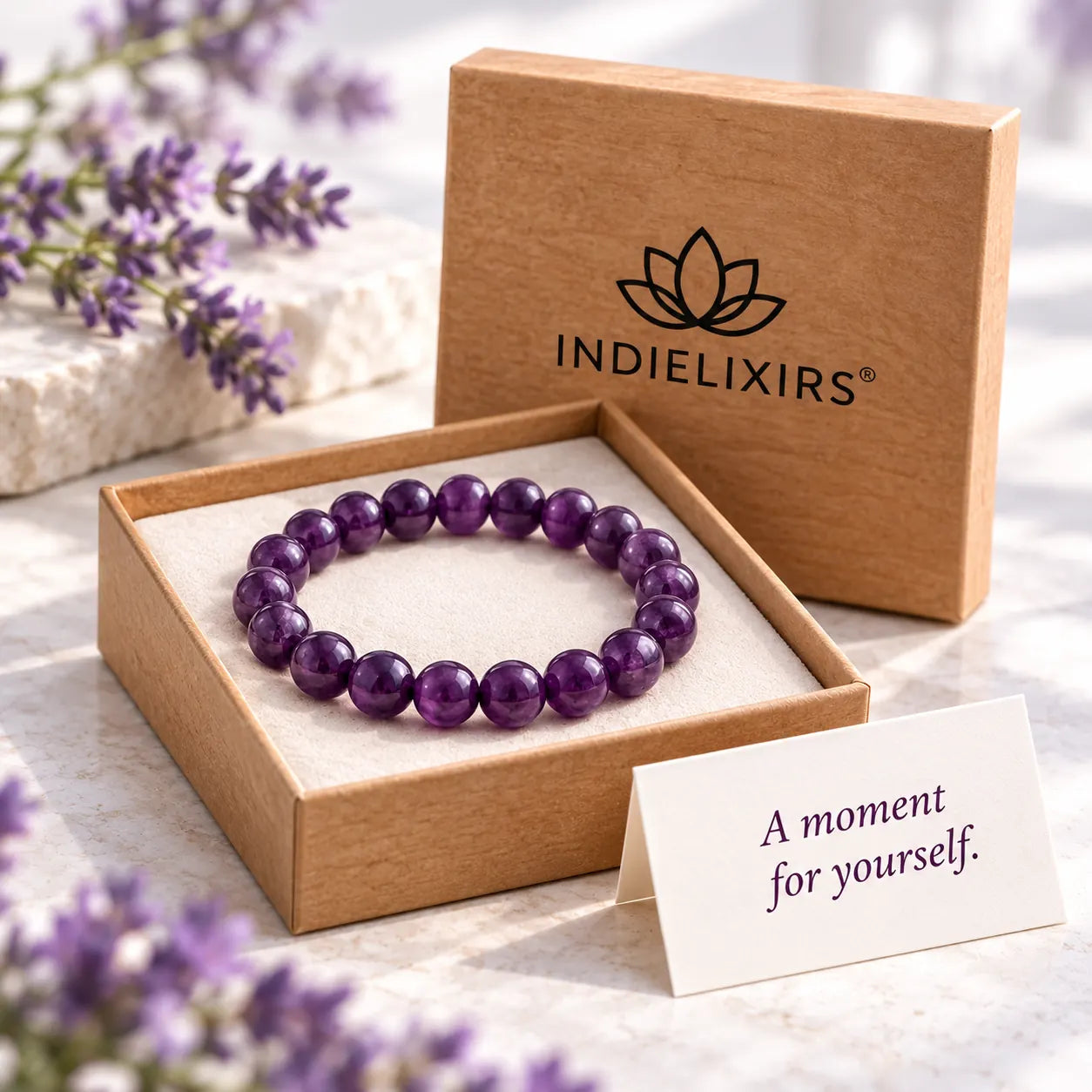Purple Amethyst bracelet in an INDIELIXIRS presentation box beside a gift card reading A moment for yourself