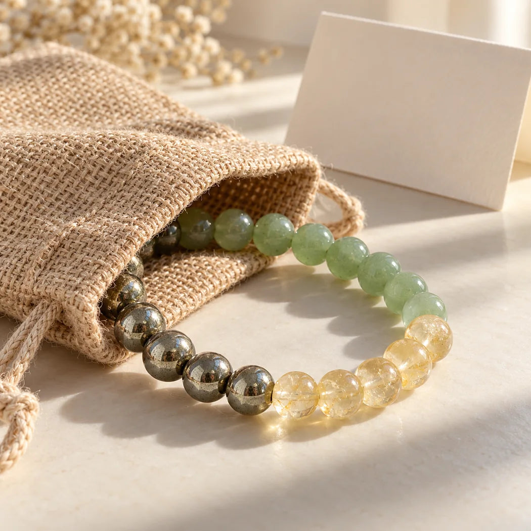 Three-stone bracelet partly emerging from a natural jute gifting pouch