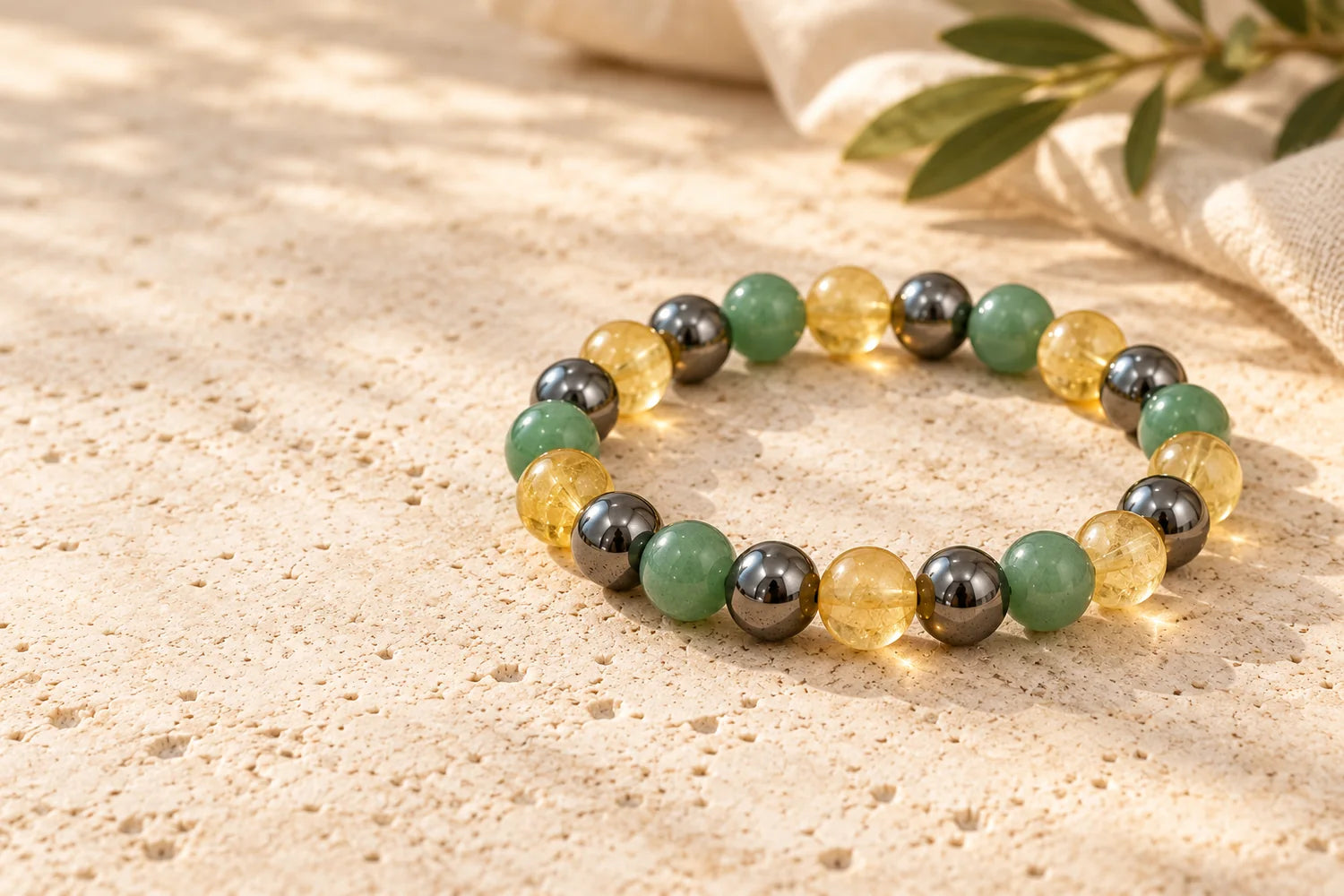 Editorial visualisation of the three-stone Wealth Bracelet on ivory stone