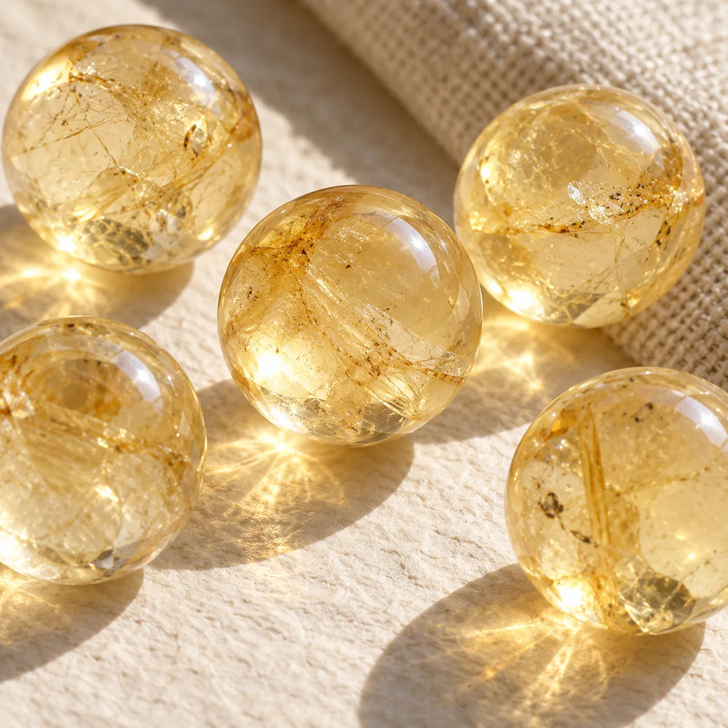 Extreme close-up of pale yellow translucent citrine beads on ivory linen